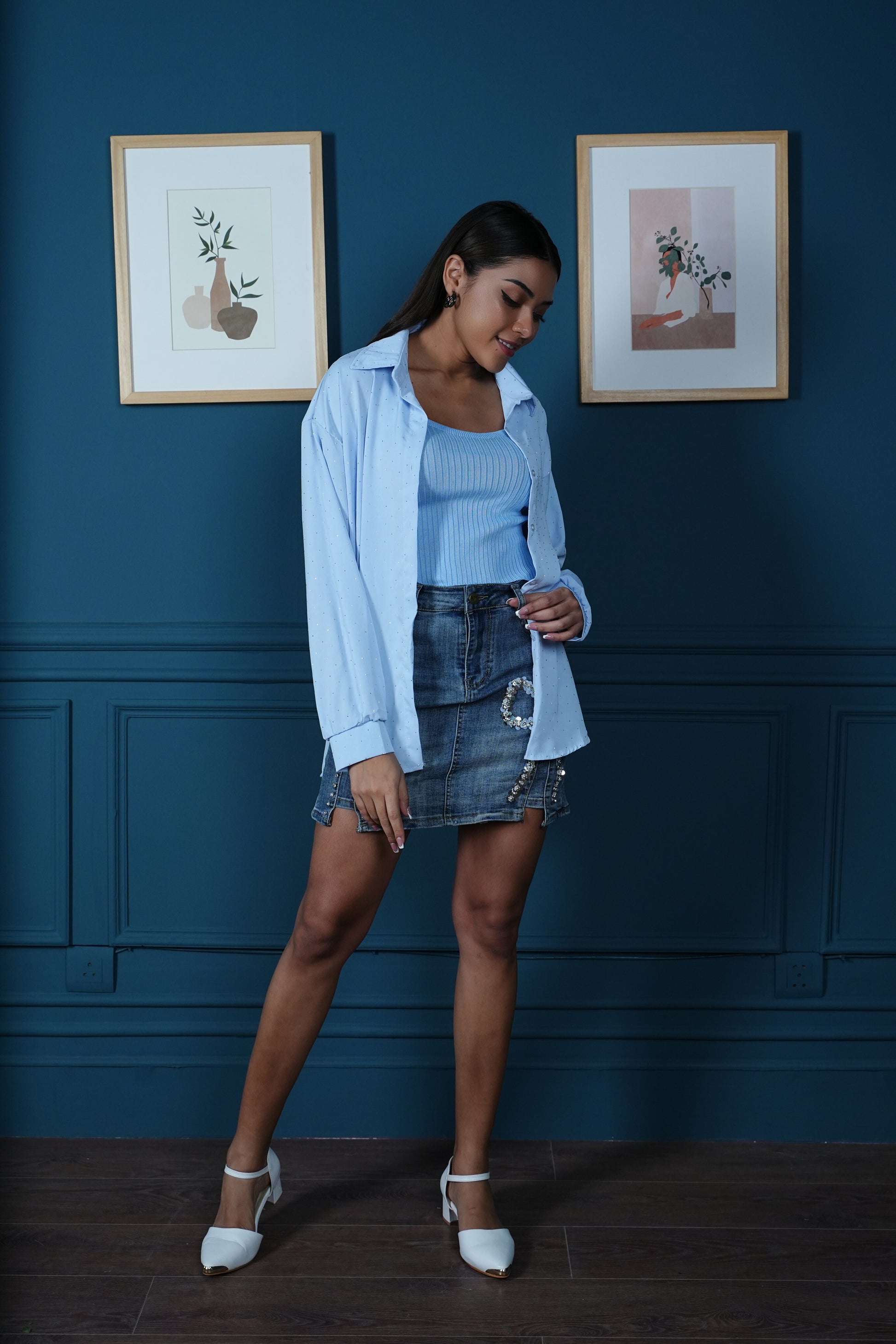 Oversized studded shirt layered over cropped ribbed cami styled for casual chic look